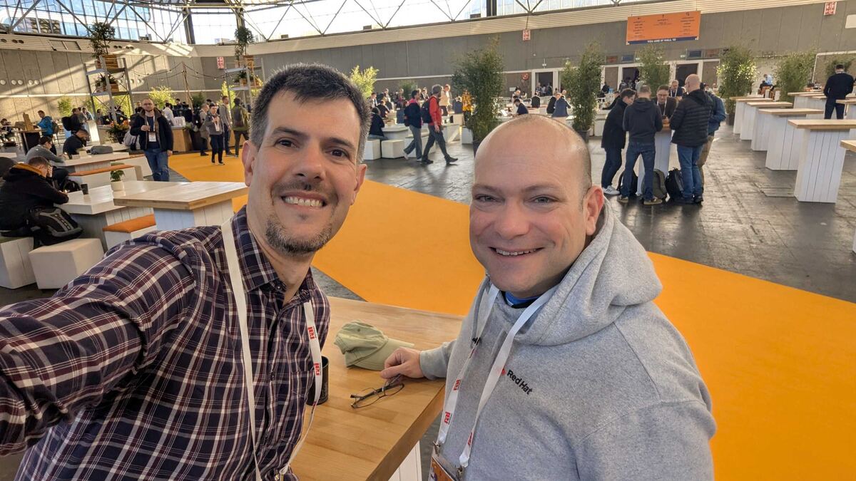 Luca Berton meeting fellow engineers at KubeCon Europe 2026 Amsterdam expo hall
