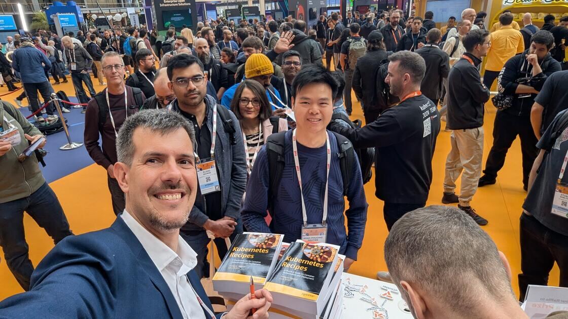 Luca Berton signing Kubernetes Recipes books at KubeCon Europe 2026 Amsterdam
