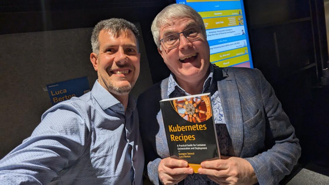Luca Berton and Grzegorz Stencel with Kubernetes Recipes book at KubeCon Europe 2026