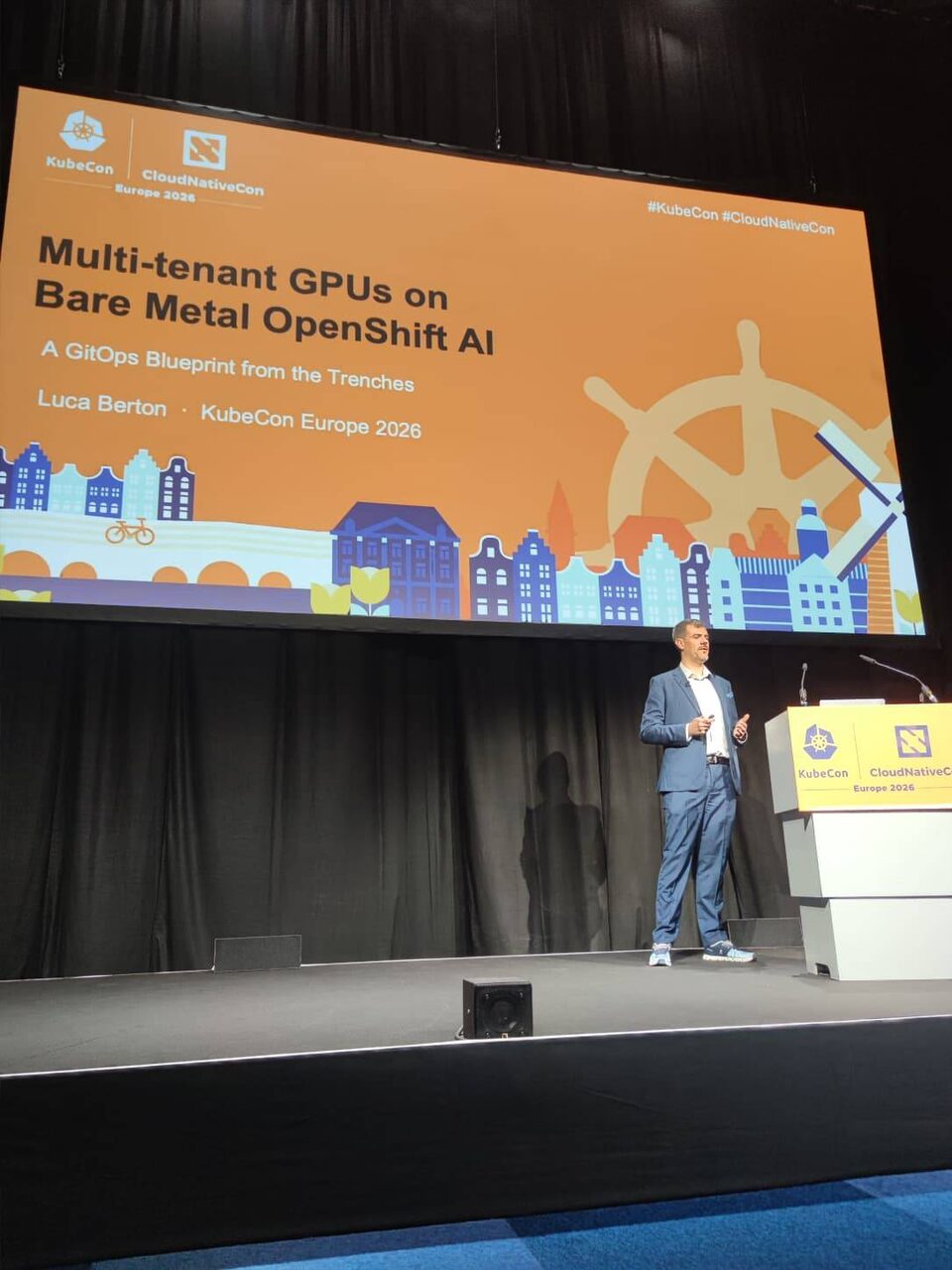 Wide shot of Luca Berton presenting on the main KubeCon CloudNativeCon Europe 2026 stage