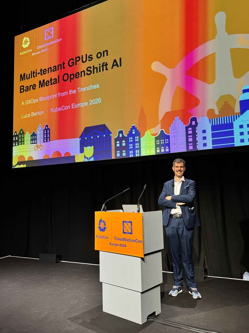 Luca Berton on stage at KubeCon Europe 2026 with Multi-tenant GPUs on Bare Metal OpenShift AI title slide