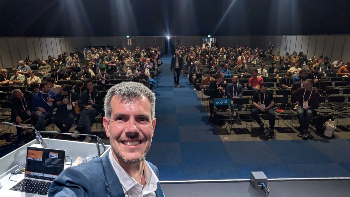 Luca Berton speaking to a packed room at KubeCon Europe 2026 Amsterdam