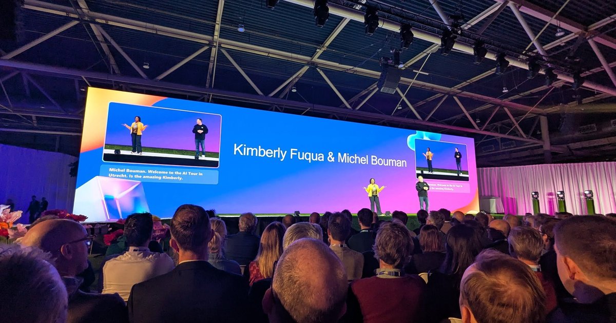 Keynote stage at the Microsoft AI Tour in Utrecht with two presenters and a wide screen, and the audience in the foreground