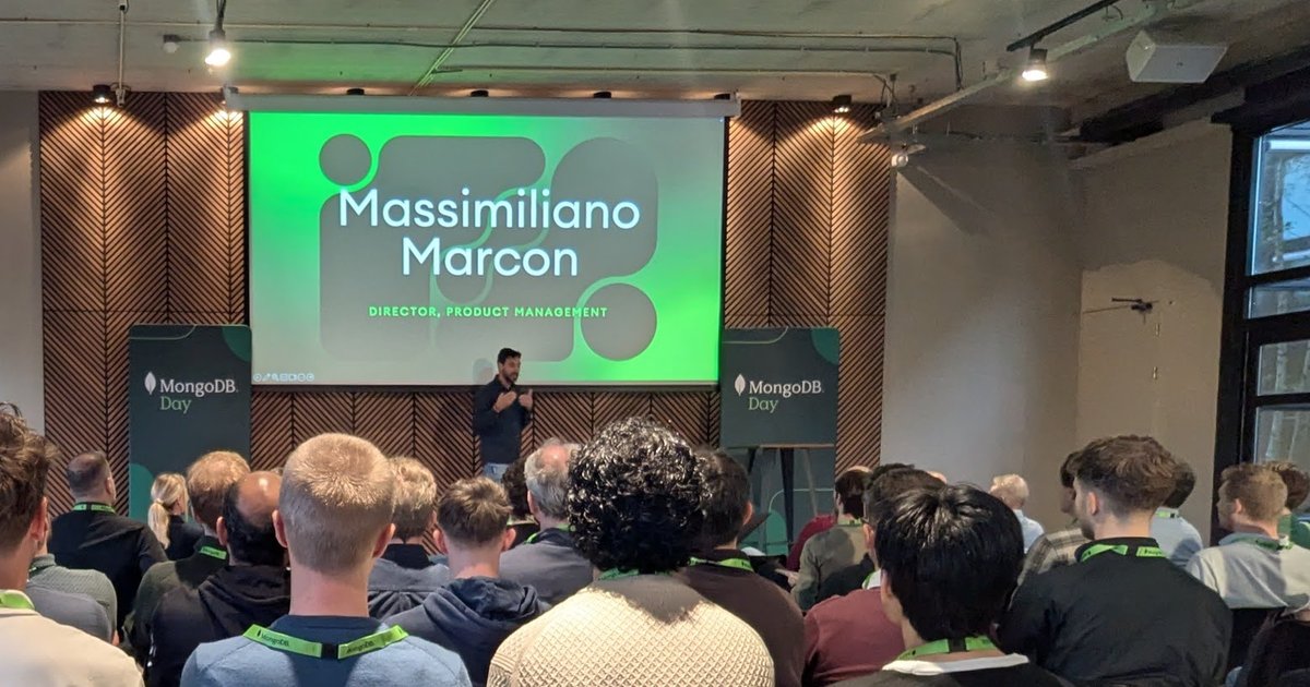 MongoDB Day Amsterdam 2025 opening keynote, with Massimiliano Marcon, Director, Product Management, on the screen between two MongoDB Day banners and a full room