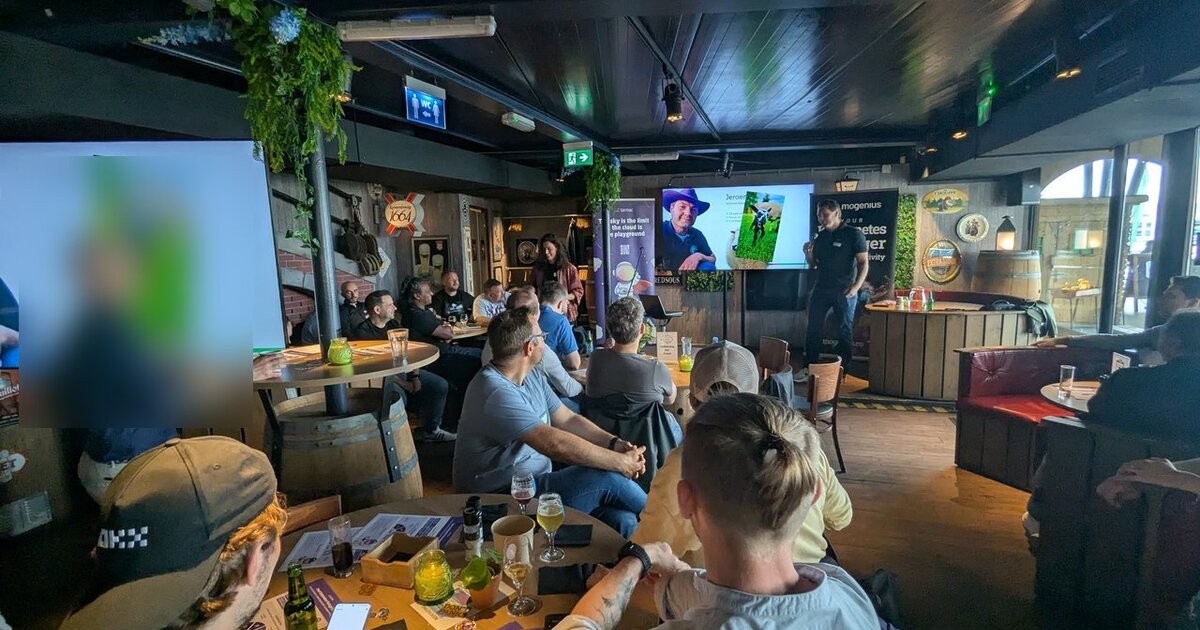 Platform Engineering Amsterdam meetup at Waterfront in Amsterdam, with an intro slide on the screens next to tarmac and mogenius banners