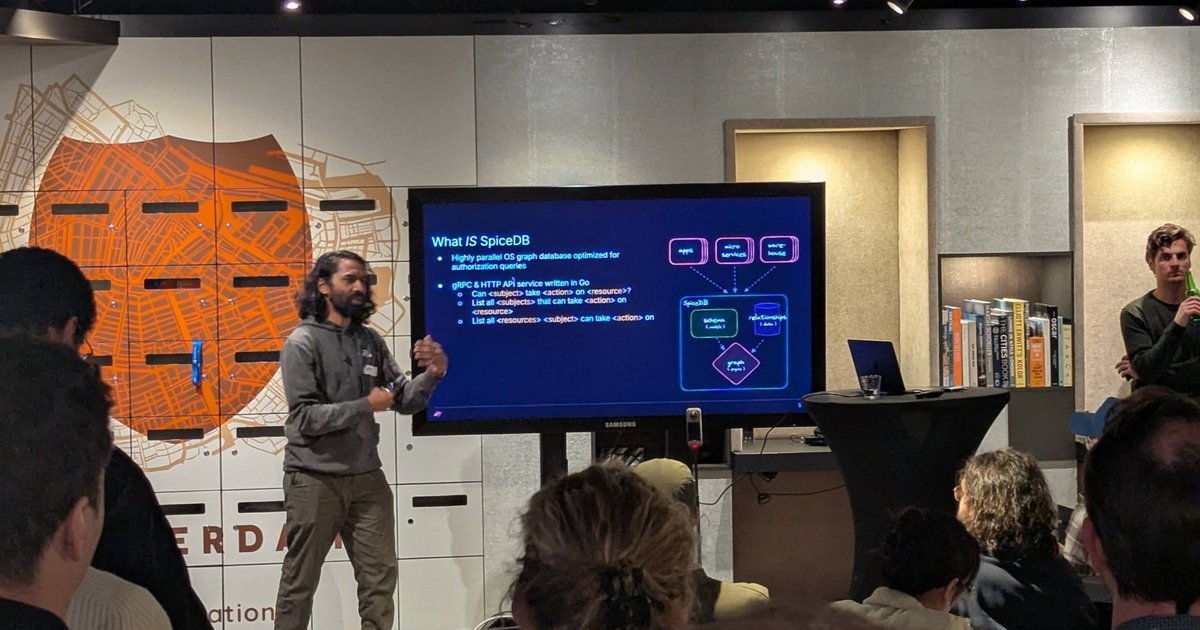 A SpiceDB talk at the Building Autonomous Systems meetup in Amsterdam, with the What IS SpiceDB slide on screen