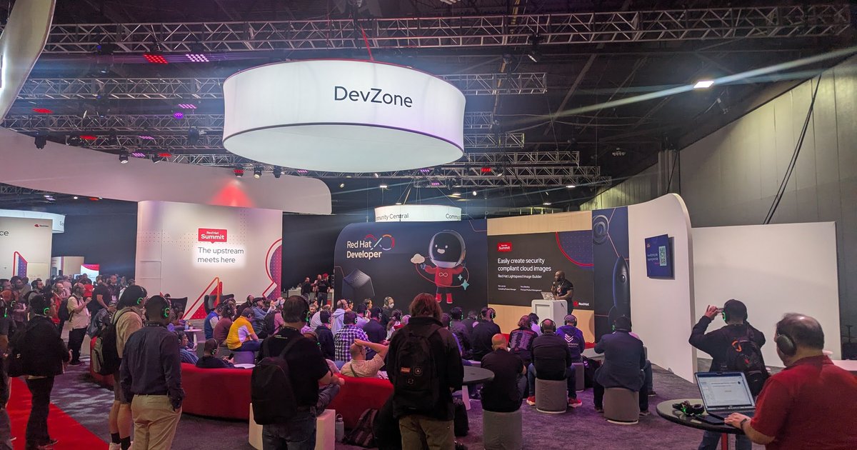 The DevZone area at Red Hat Summit 2026 with attendees watching a talk
