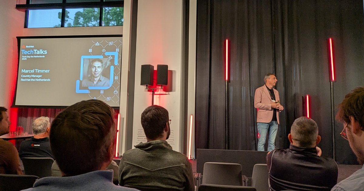 Red Hat Country Manager for the Netherlands on stage opening Red Hat Tech Day Netherlands 2025, with his introduction slide on the screen