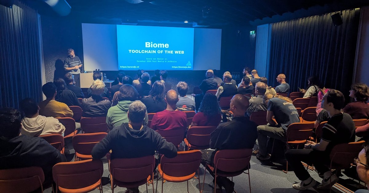 A full room at the December 2024 Rust meetup at JetBrains Amsterdam, with the Biome Toolchain of the Web title slide