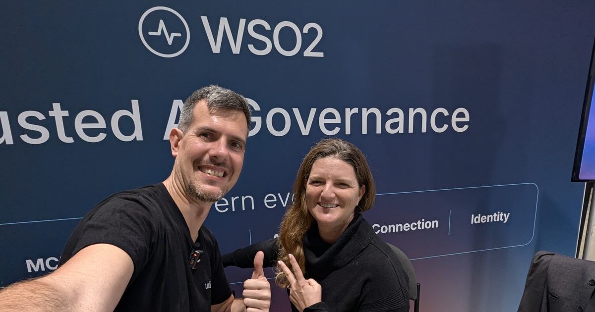 Luca Berton and Rania Khalaf at the WSO2 booth, under a banner about trusted AI governance and identity