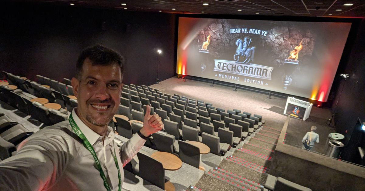 Luca Berton in an empty session room at Techorama Netherlands 2026, the screen announcing the medieval edition